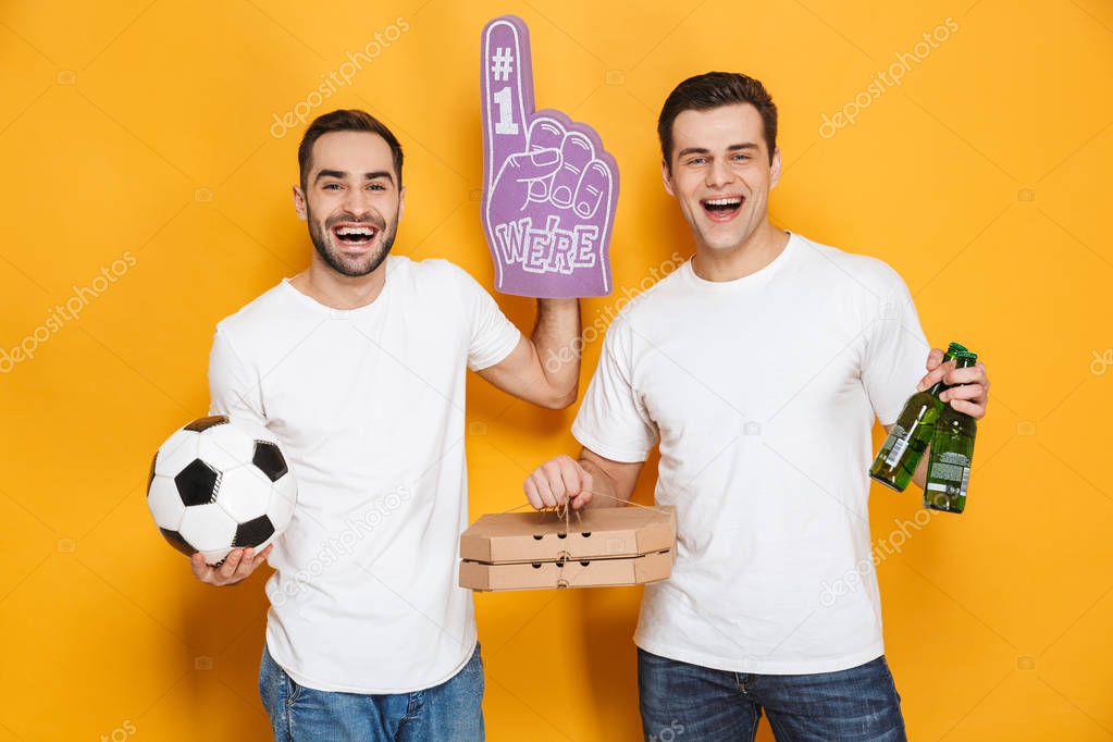 Image of two optimistic men supporter 30s in white t-shirts hold