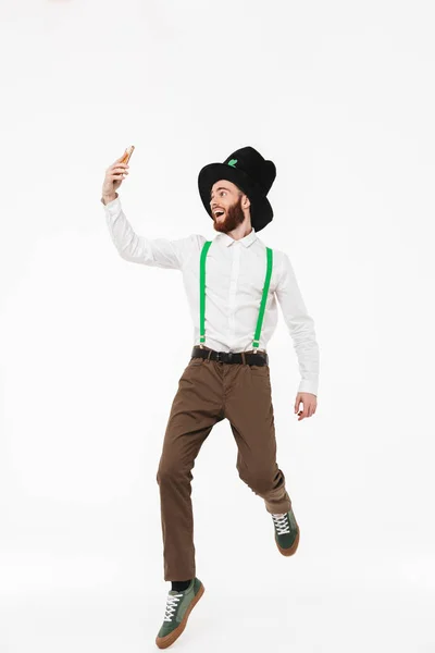 Full length of a cheerful young man celebrating — Stock Photo, Image