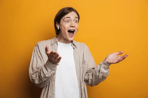 Happy surprised handsome man in shirt rejoices and looking away