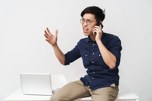 Photo of nervous asian businessman talking on smartphone while w — Stock Photo, Image