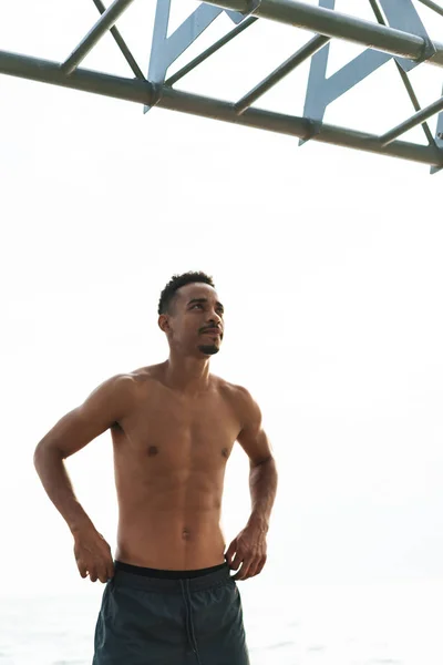 Handsome young african sports man outdoors at the beach sea walking make exercises. — Stock Photo, Image