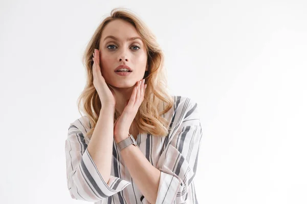 Portrait of blond european woman wearing wrist watch looking at camera with hand on her face — Stock Photo, Image