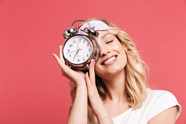 Portrait of beautiful young woman 20s wearing sleeping mask hold