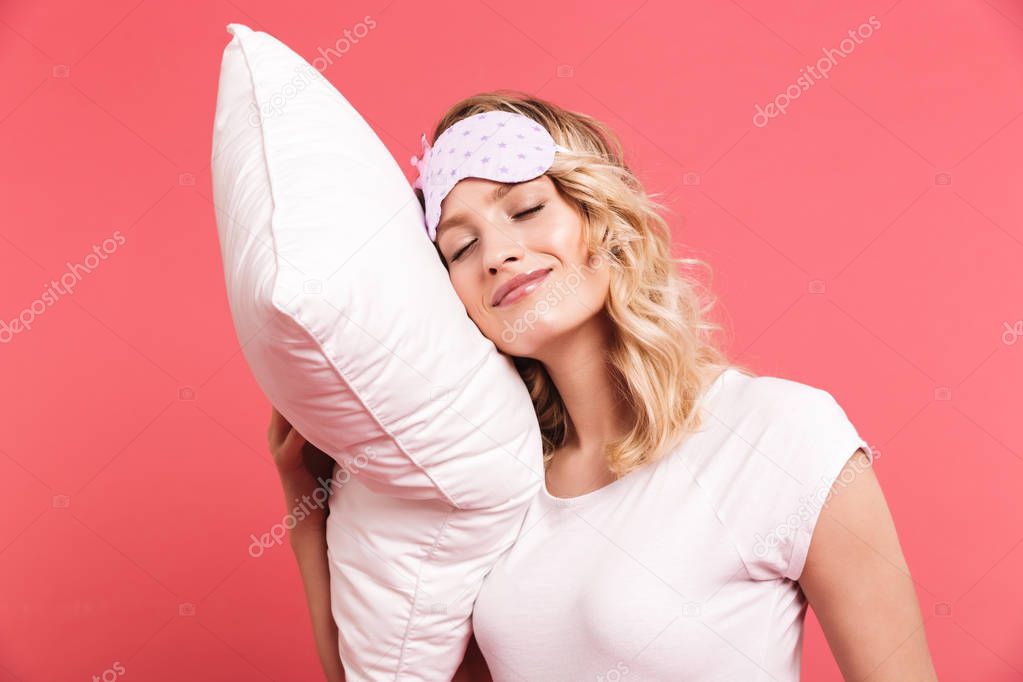 Portrait of beautiful young woman 20s wearing sleeping mask hold