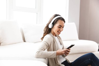 Evde bir kanepede rahatlatıcı gülümseyen güzel kız