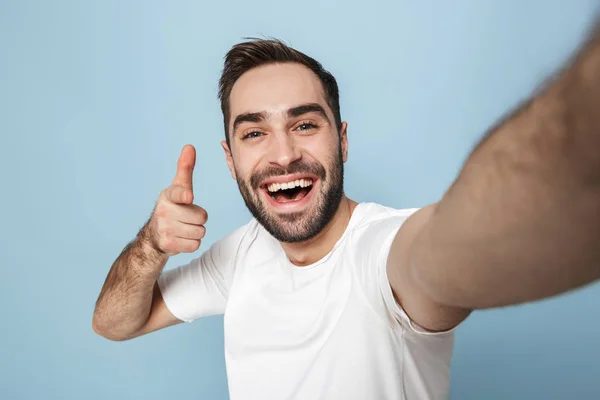 Alegre animado homem vestindo branco t-shirt de pé — Fotografia de Stock