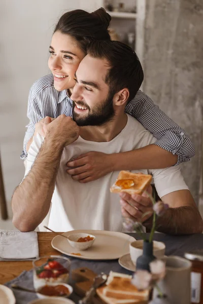 Happy cheerful couple having tasty breakfast — Stock Photo, Image