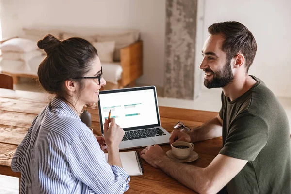 Immagine di una coppia bruna positiva che lavora insieme su laptop whi — Foto Stock