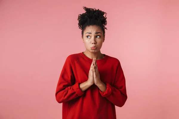 Nerveuze Afrikaanse vrouw poseren geïsoleerd over roze muur achtergrond te maken hoopvol gelieve gebaar. — Stockfoto