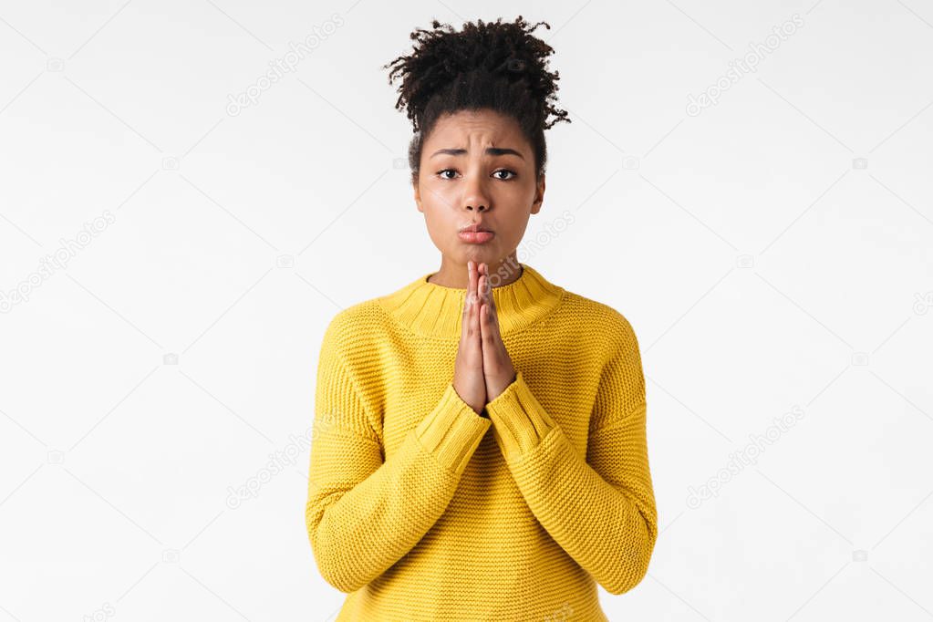 Emotional woman posing isolated over white wall background make hopeful please gesture.