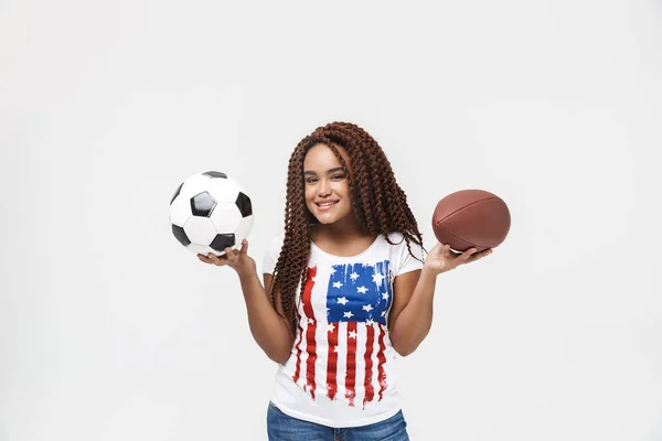 Πορτραίτο της ευτυχης αφρικανικής Αμερικάνικης γυναίκας που κρατά ράγκμπι και ποδόσφαιρο — Φωτογραφία Αρχείου