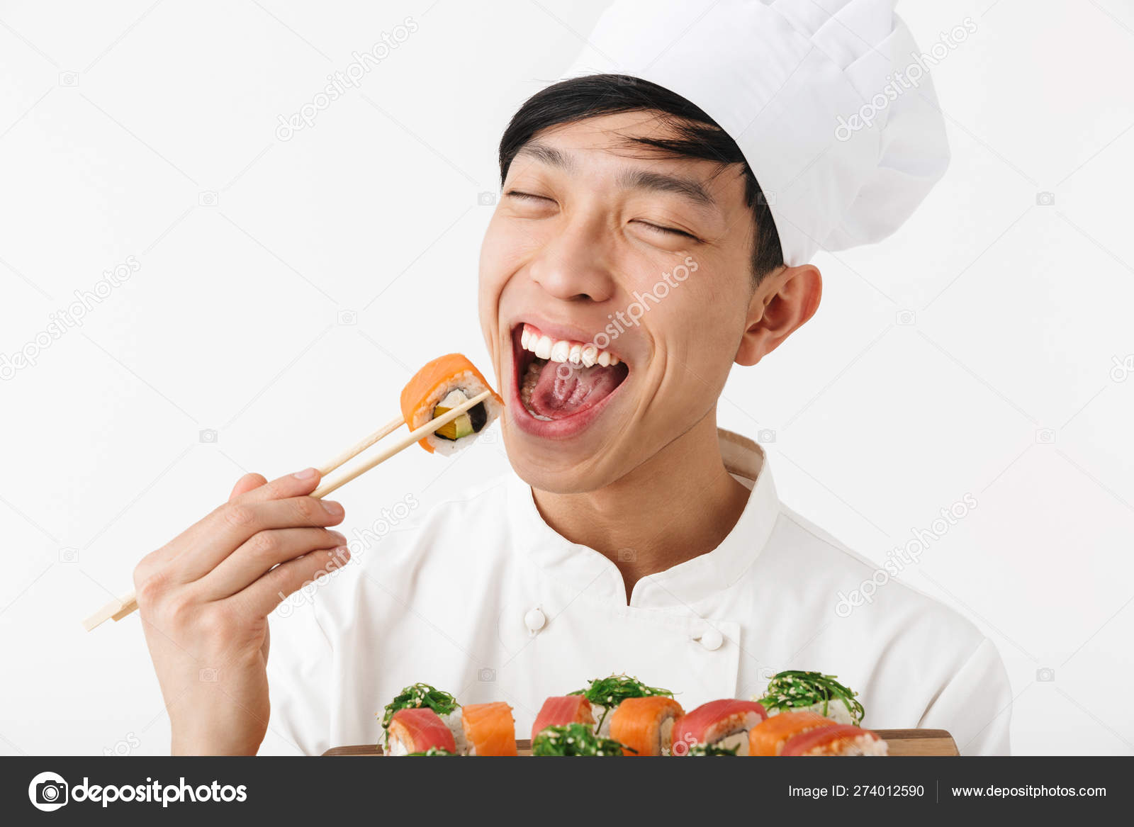 Excited asian chef wearing uniform standing Stock Photo by