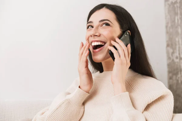 Close up of a happy young girl relaxing on a couch — Stock Photo, Image