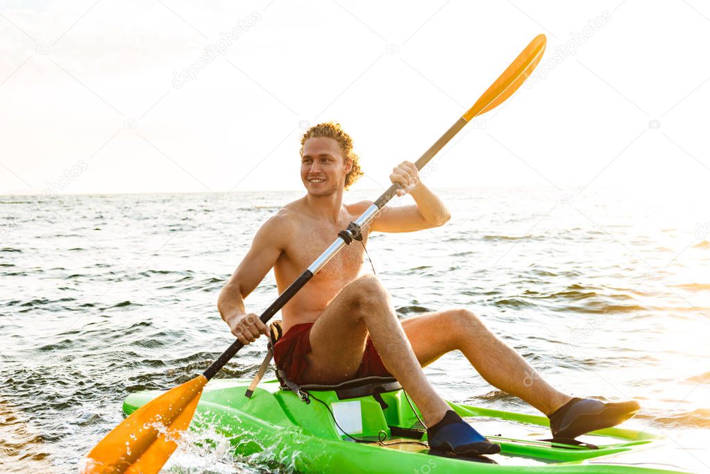 Healthy strong man kayaking