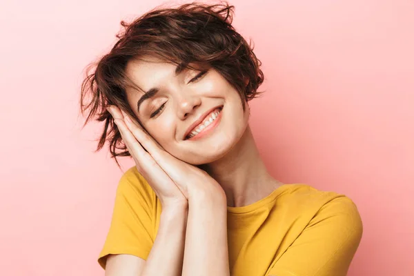 Agradable hermosa mujer posando aislado sobre fondo de pared rosa listo para dormir . — Foto de Stock