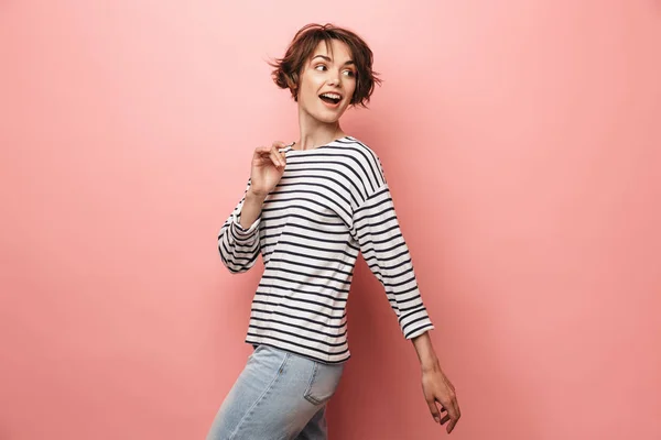 Happy beautiful woman posing isolated over pink wall background.