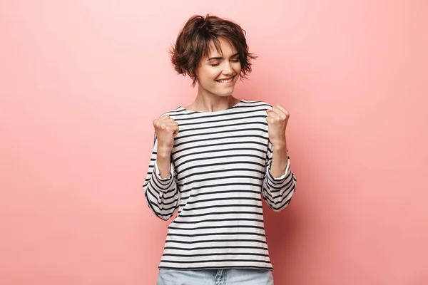Woman posing isolated over pink wall background make winner gesture. — ストック写真