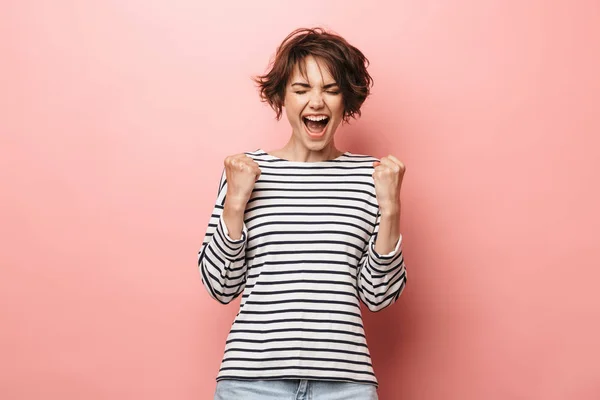 Woman posing isolated over pink wall background make winner gesture. — ストック写真