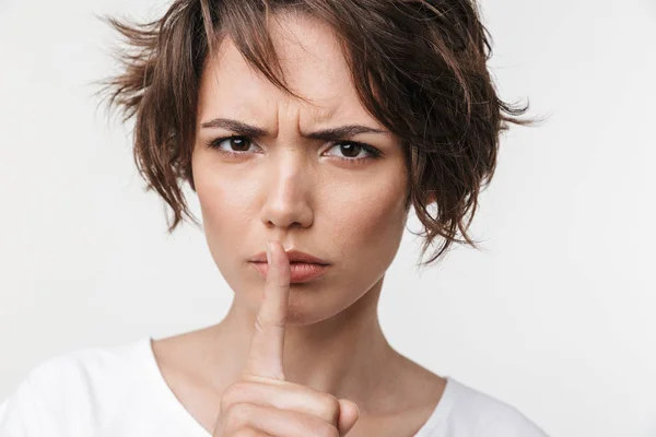 Beautiful young pretty displeased sad woman posing isolated over white wall background showing silence gesture. Royalty Free Stock Photos