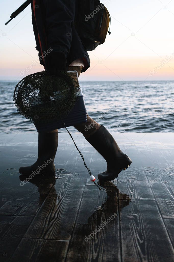 Cropped image of a fisherman wearing coat