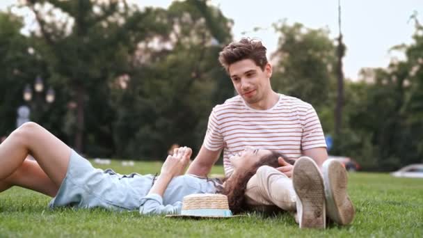 Happy Romantic Couple Sitting Grass Talking Each Other — Stock Video