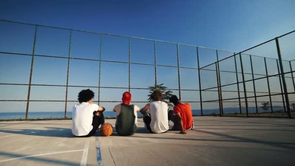 Back View Four Multiethnic Friends Sitting Together Playground — Stock Video