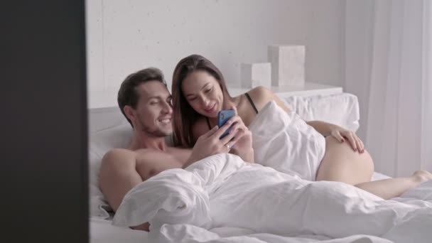 Happy Loving Couple Using Smartphone While Lying Together Bed Home — Stock Video