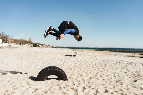 Foto de un tipo atrevido haciendo parkour y saltando durante el acrob de la mañana —  Fotos de Stock