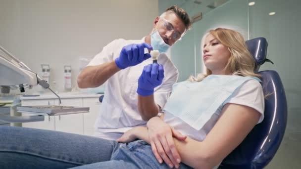 Mulher Loira Concentrada Conversando Com Dentista Sobre Problema Com Dente — Vídeo de Stock