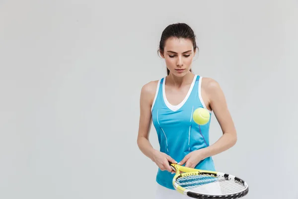 Sport fitness woman tennis player make exercises isolated over grey wall background. — Stock Photo, Image