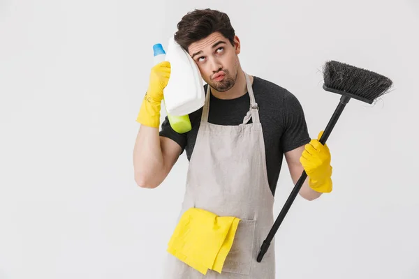 Handsome brunette houseman wearing apron — Stock Photo, Image