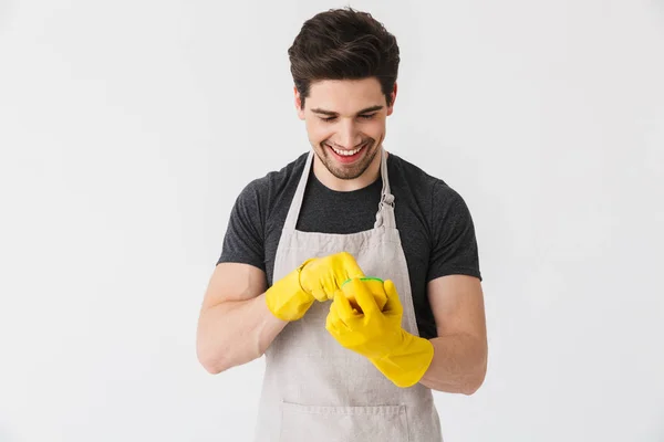 Handsome brunette houseman wearing apron — Stock Photo, Image