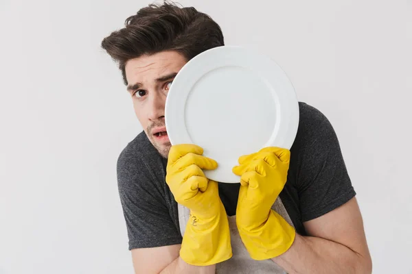 Photo of optimistic young man wearing yellow rubber gloves for h — Stock Photo, Image