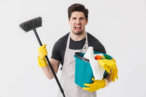 Handsome brunette houseman wearing apron — Stock Photo, Image