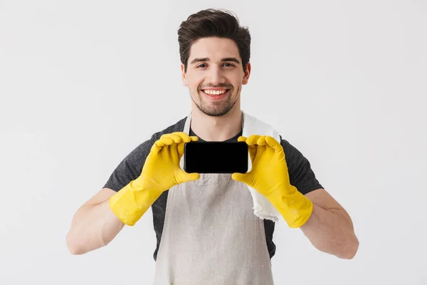 Handsome brunette houseman wearing apron — Stock Photo, Image