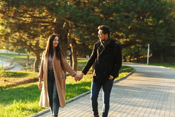 Young beautiful loving couple posing walking outdoors in park nature. — Stock Photo, Image