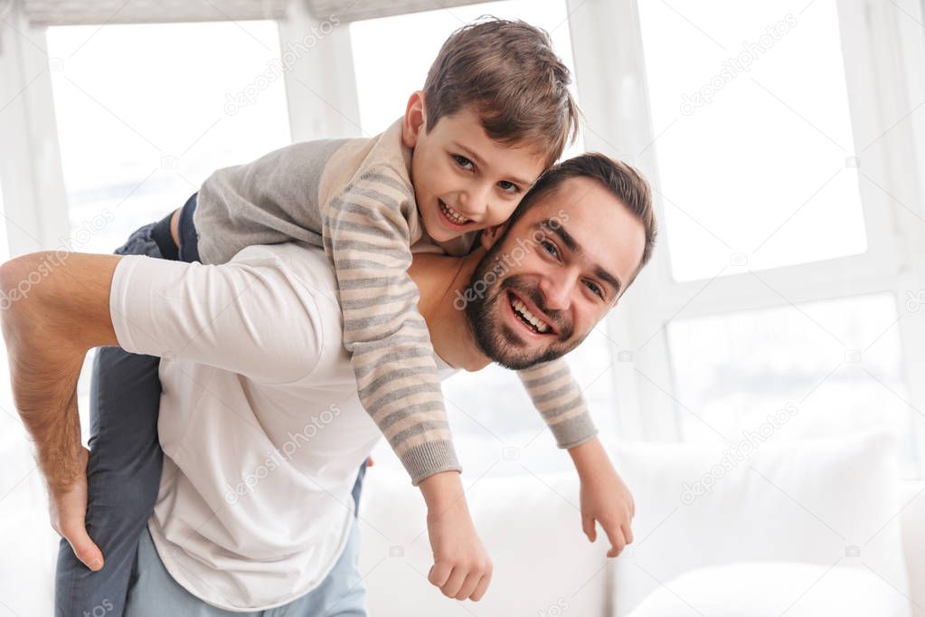 Happy father and his son piggyback riding