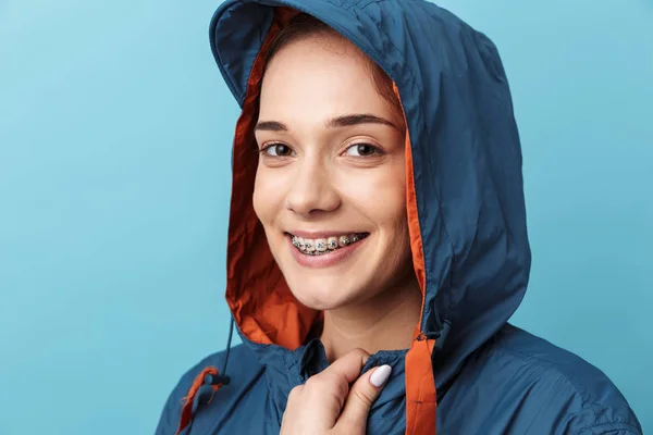 Jovem alegre vestindo capa de chuva de pé — Fotografia de Stock