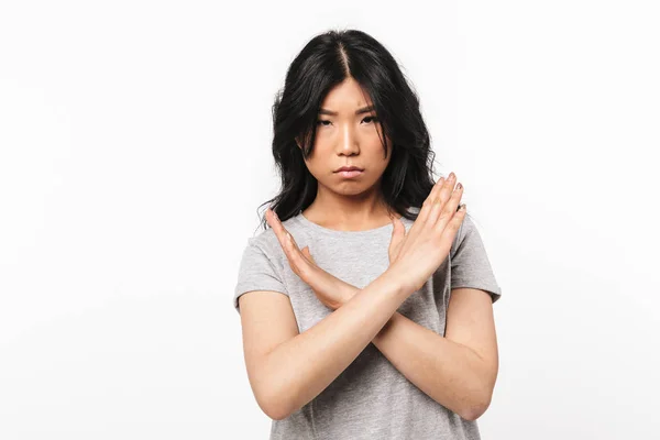 Serious asian beautiful young woman posing isolated over white wall background showing stop gesture. — Stock Photo, Image