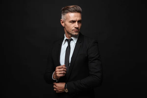 Portrait of european handsome businessman dressed in formal suit posing and looking aside — Stock Photo, Image