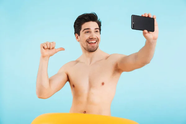 Cheerful shirtless man standing isolated over blue — Stock Photo, Image