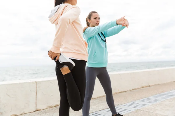 Dos jóvenes y atractivas mujeres de fitness con sudaderas — Foto de Stock