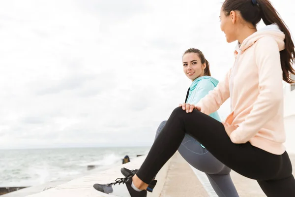 Dos jóvenes y atractivas mujeres de fitness con sudaderas — Foto de Stock