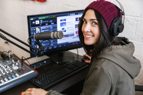 Beautiful happy young female radio host broadcasting