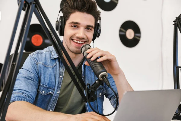 Cheerful young man radio host broadcasting