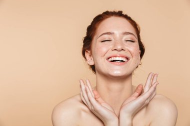 Bej duvar arka plan üzerinde izole poz Amazing genç kızıl saçlı kadın.