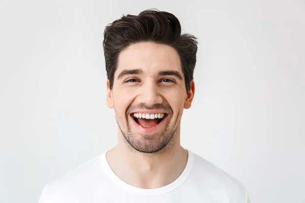 Feliz joven emocionado hombre emocional posando aislado sobre fondo blanco de la pared . —  Fotos de Stock