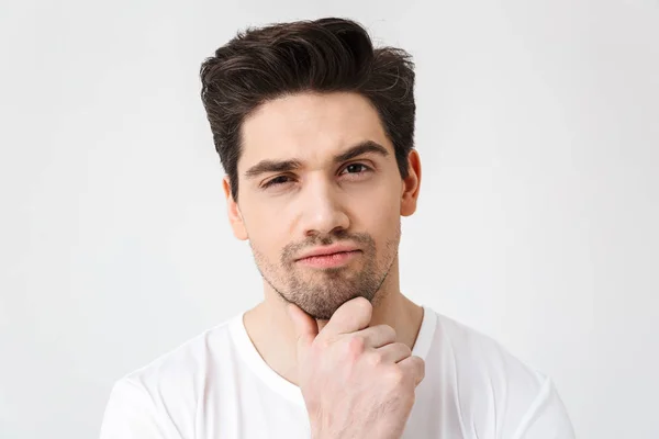 Serious concentrated young man posing isolated over white wall background. — Stock Photo, Image