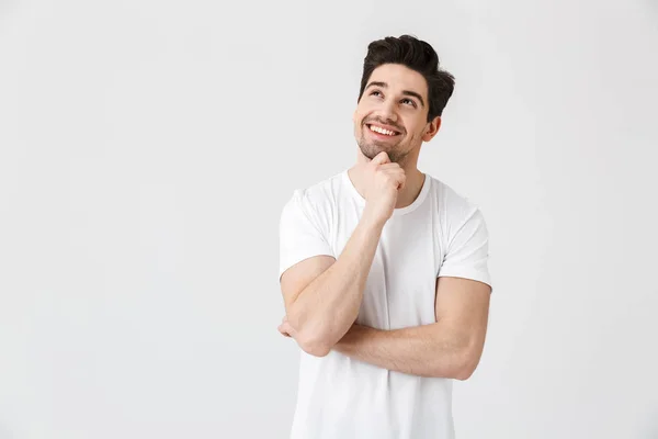 Feliz joven emocionado hombre emocional posando aislado sobre fondo blanco de la pared . — Foto de Stock