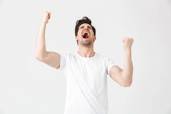 Emocionado joven feliz posando aislado sobre fondo de pared blanco . — Foto de Stock